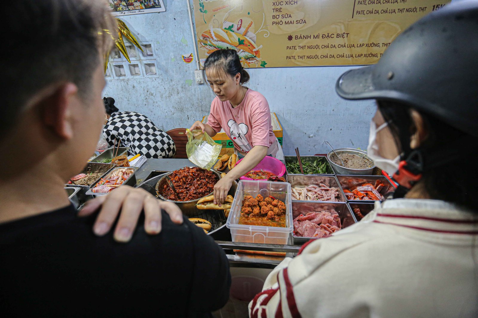Cận cảnh một thực khách đang thưởng thức bánh mì O Tho Trần Cao Vân giòn rụm, nóng hổi
