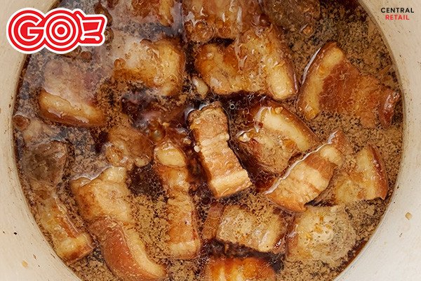 Cho trứng luộc đã bóc vỏ vào nồi thịt kho trứng đang sôi
